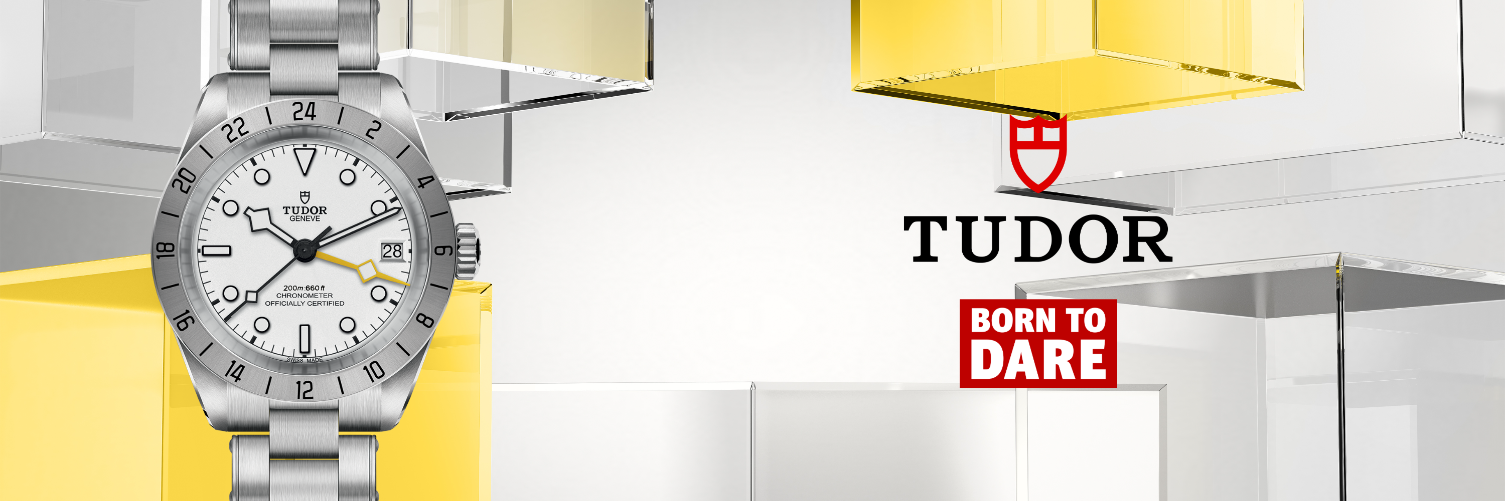 Auf der linken Seite ist eine silberne Tudor-Armbanduhr mit weißem Zifferblatt abgebildet. Das Tudor-Logo und der Slogan Born to Dare erscheinen auf der rechten Seite vor einem Hintergrund aus gelben und klaren Glassteinen.