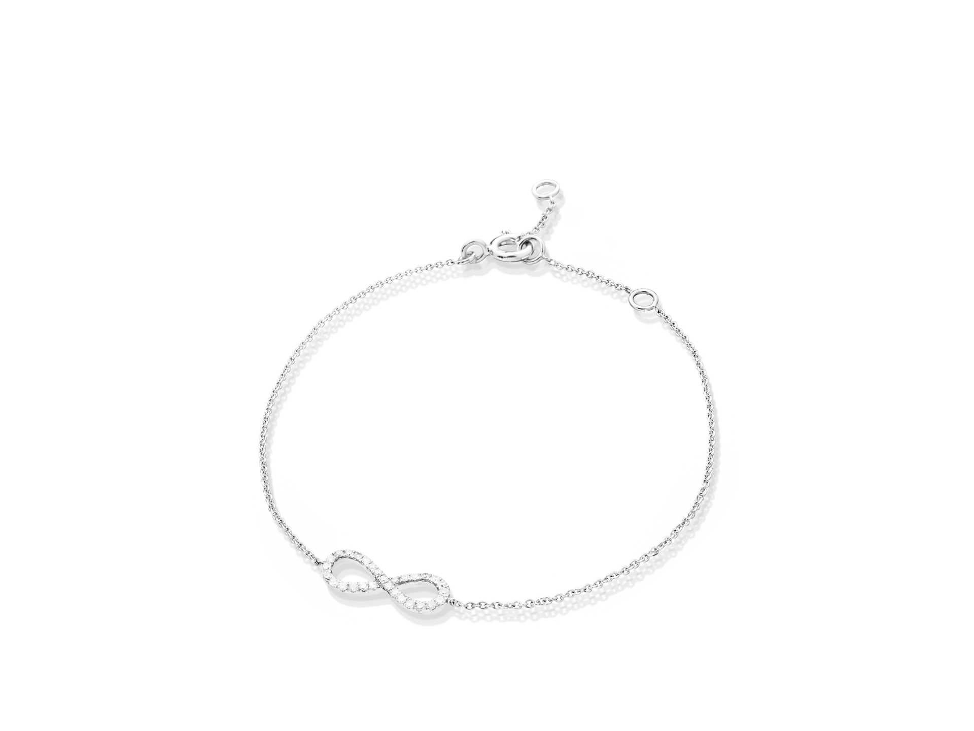 Das INFINITY ARMBAND von Schullin ist ein elegantes Armband aus Weißgold, das mit einem Infinity-Zeichen verziert ist, das mit winzigen, glitzernden Steinen besetzt ist. Es verfügt über eine verstellbare Kette und einen kleinen Verschluss für sicheren Halt.