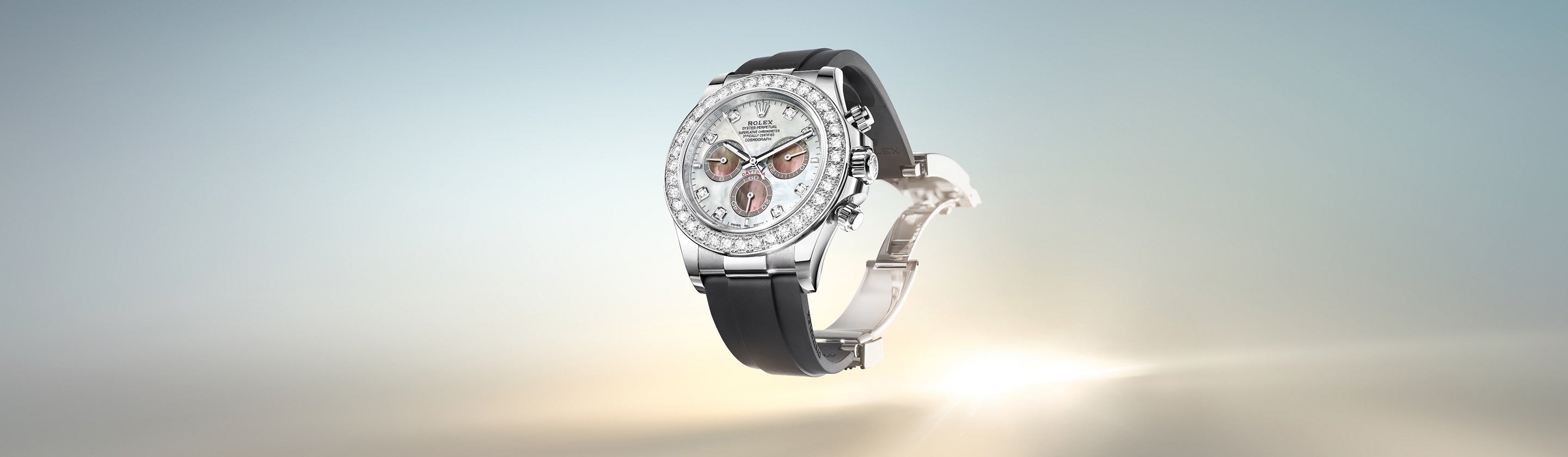 Eine Luxusuhr mit diamantbesetzter Lünette, silber-weißem Zifferblatt und schwarzem Armband, präsentiert vor einem Hintergrund mit sanftem Farbverlauf und leuchtender Unterseite.