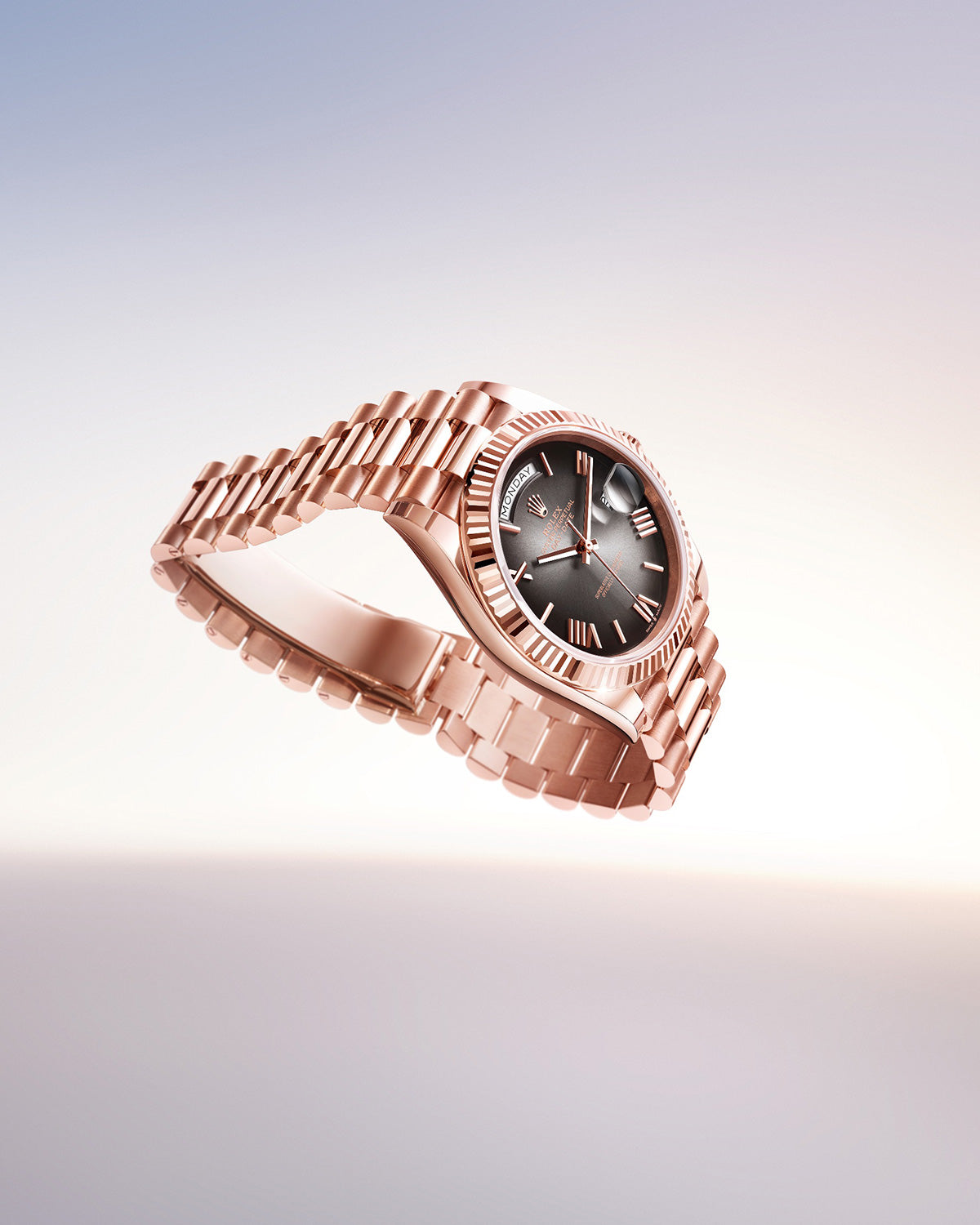 Eine luxuriöse Armbanduhr aus Roségold, die anmutig vor einem Hintergrund mit sanftem Farbverlauf schwebt. Sie verfügt über ein schwarzes Zifferblatt mit silbernen Stundenmarkierungen und einer geriffelten Lünette, die ihr elegantes Design hervorhebt. Das Armband hat polierte Glieder, die einen Hauch von Raffinesse verleihen.