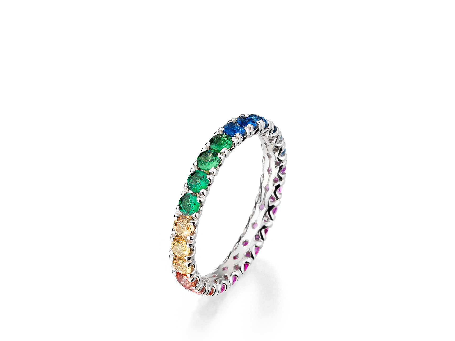 Ein atemberaubender MEMOIRE RING RAINBOW aus Weißgold von Schullin, verziert mit einer Reihe von Saphiren in einem regenbogenfarbenen Farbverlaufsmuster. Der Ring ist mit roten, orangefarbenen, gelben, grünen und blauen Steinen verziert, die elegant entlang des Bandes angeordnet sind.